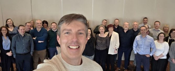 AI keynote speaker Mark Kelly with business leaders after an executive AI workshop