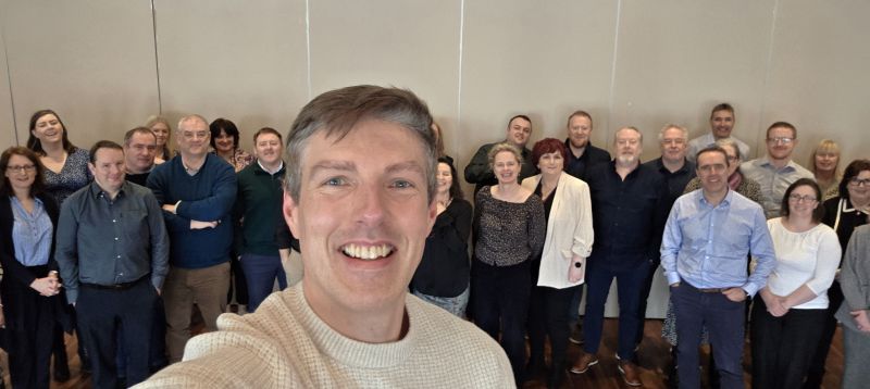 AI keynote speaker Mark Kelly with business leaders after an executive AI workshop