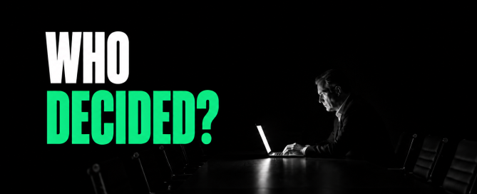 An executive sits alone at a dark boardroom table beside the words “Who Decided?”, highlighting accountability for AI-assisted decisions.