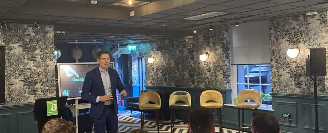 Mark Kelly delivering an AI keynote to business leaders at a Guaranteed Irish event
